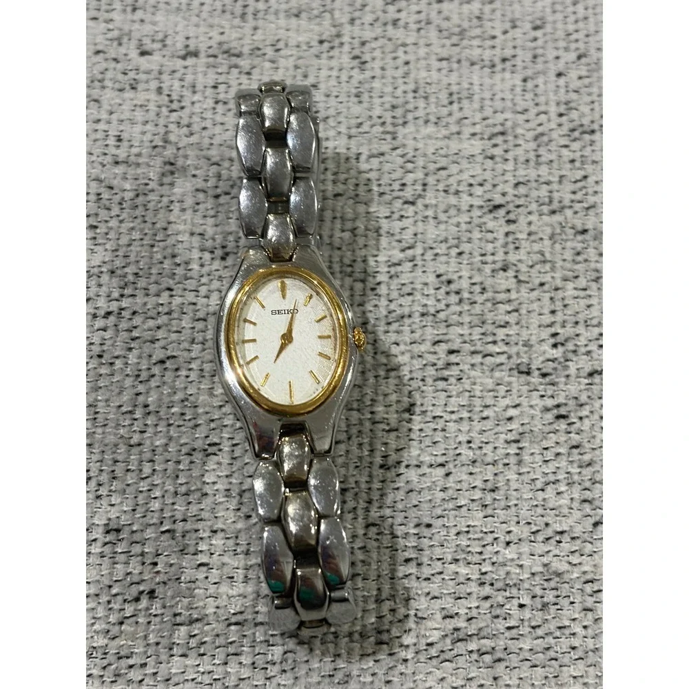 Seiko Oval Women's Two Tone Silver and Gold Wrist  Sunburst Dial Watch 1N00-6F80
